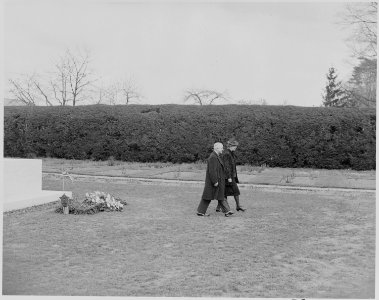Photograph of President Truman and Eleanor Roosevelt walking away from the grave of Franklin D. Roosevelt after... - NARA - 199368 photo