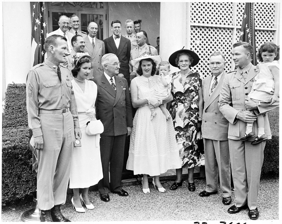 Photograph of President Truman posing in the White House Rose Garden with First Lieutenant Henry Commiskey of the... - NARA - 200325