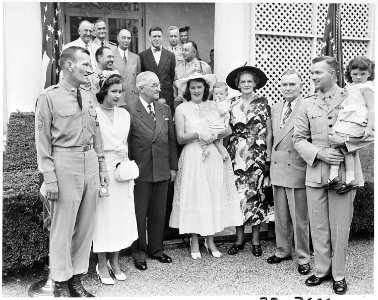Photograph of President Truman posing in the White House Rose Garden with First Lieutenant Henry Commiskey of the... - NARA - 200325