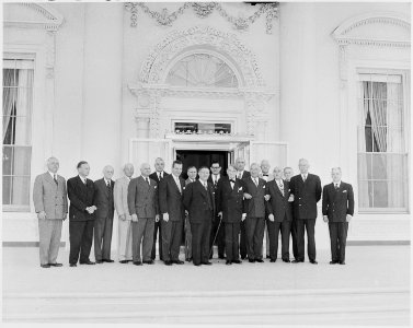 Photograph of President Truman posing outside the newly renovated White House with members of the Commission on the... - NARA - 200193 photo