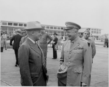 Photograph of President Truman laughing and chatting with General Dwight D. Eisenhower at the National Airport in... - NARA - 199134