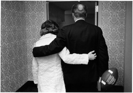 Photograph of President Gerald Ford, Carrying a Football, and First Lady Betty Ford returning to the President's... - NARA - 186776