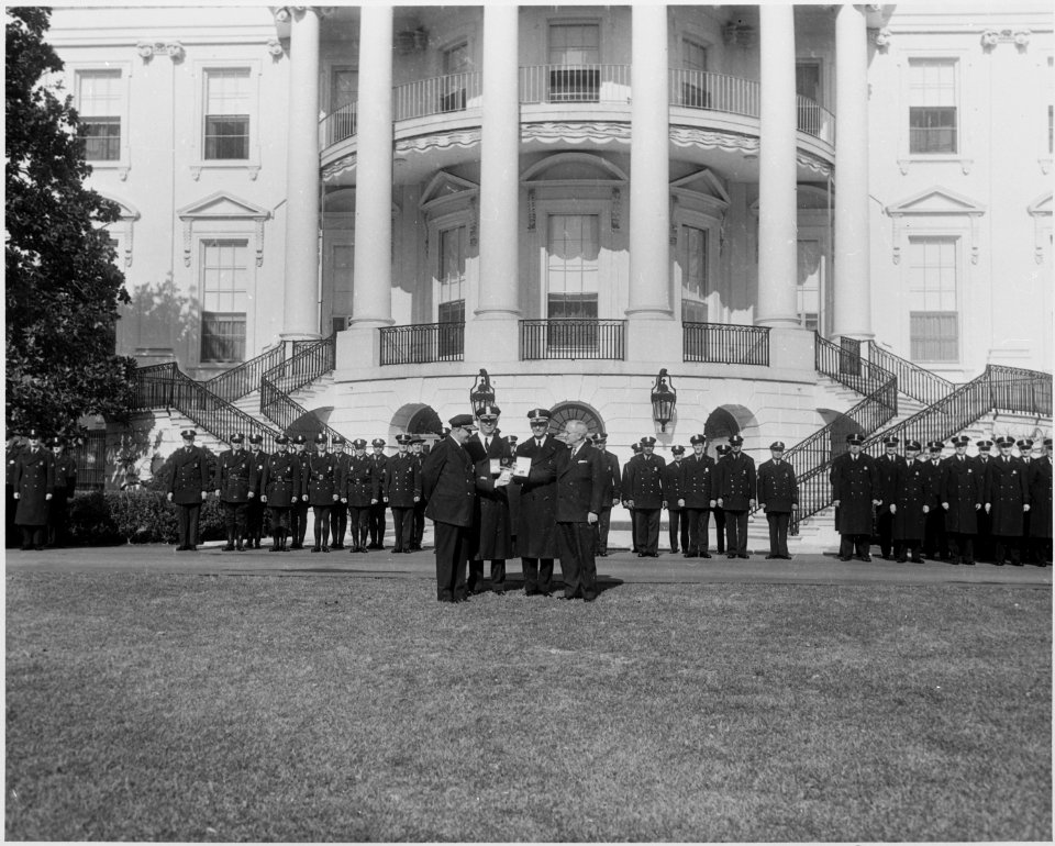 Photograph of President Truman on the White House lawn receiving honorary badges from the Washington police force... - NARA - 200416