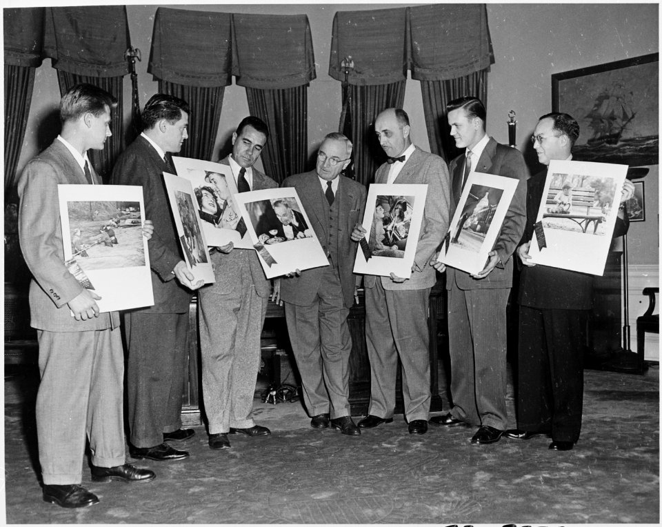 Photograph of President Truman in the Oval Office with the winners of the White House Photographers Association contest. - NARA - 200352