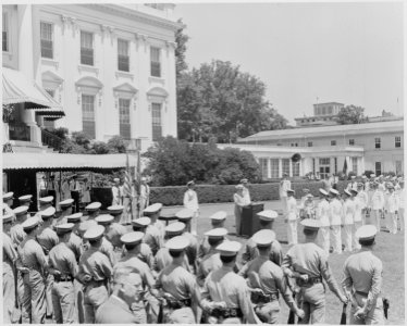 Photograph of President Truman reading a citation during a ceremony on the South Lawn of the White House at which he... - NARA - 199407