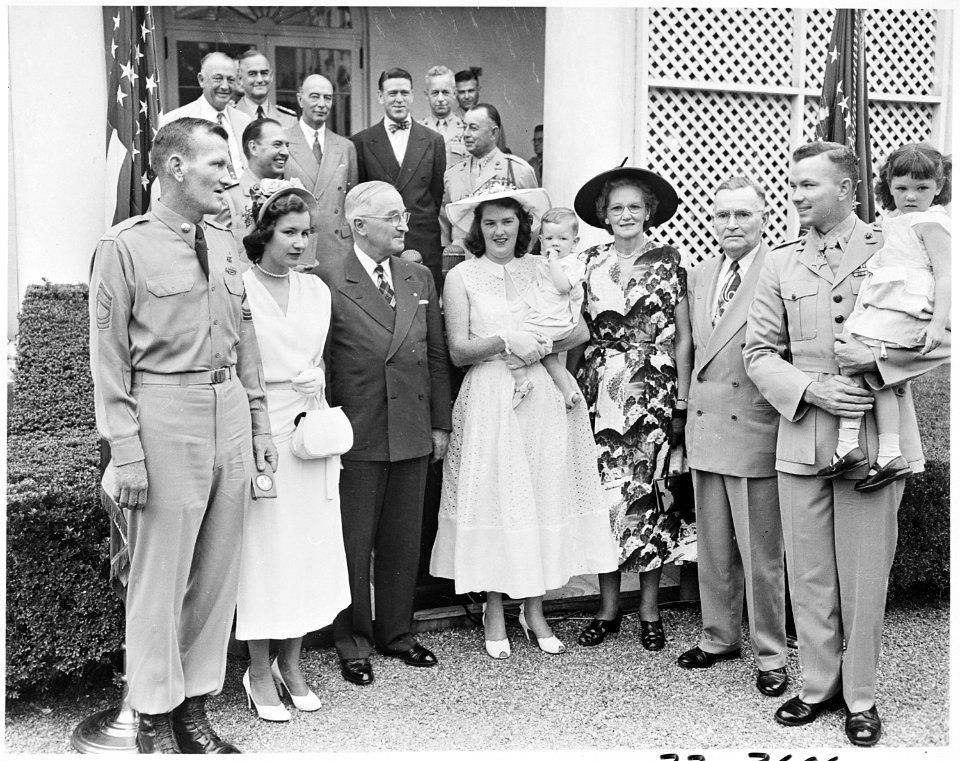 Photograph of President Truman posing in the White House Rose Garden with First Lieutenant Henry Commiskey of the... - NARA - 200325