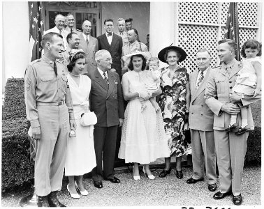 Photograph of President Truman posing in the White House Rose Garden with First Lieutenant Henry Commiskey of the... - NARA - 200325