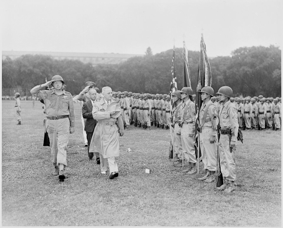 Photograph of President Truman saluting as he passes the color guard during his review of the Japanese-American 442nd... - NARA - 199389