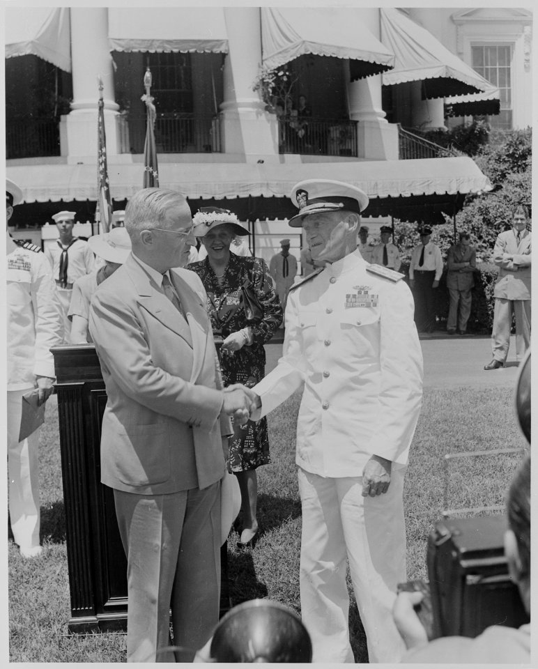 Photograph of President Truman shaking hands with Admiral Marc Mitscher, commander of the 8th Fleet and wartime... - NARA - 199397