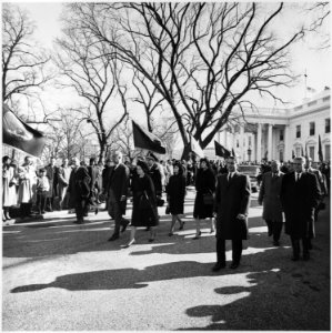 Photograph of President Lyndon B. Johnson and his family walking from the White House as part of the funeral... - NARA - 200453