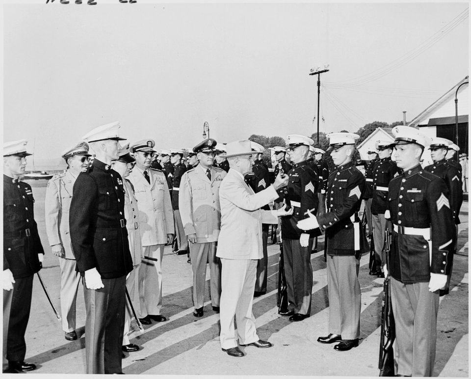 Photograph of President Truman returning a rifle to a Marine after inspecting it, as other Marines stand at... - NARA - 200215