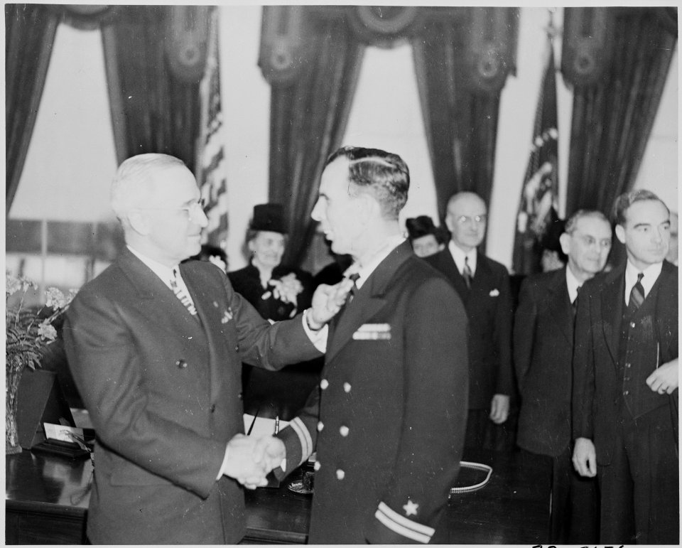 Photograph of President Truman shaking hands with Lt. Donald A. Gary (engineering officer of the U.S.S. FRANKLIN) as... - NARA - 199311