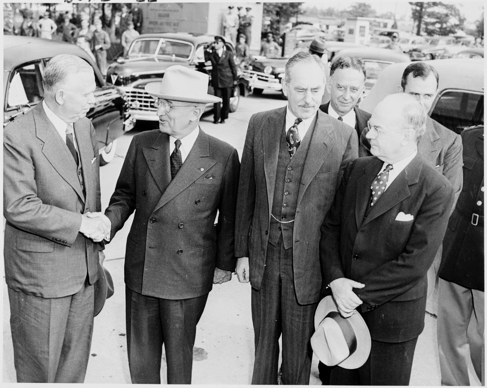 Photograph of President Truman shaking hands with Secretary of Defense George C. Marshall upon the President's return... - NARA - 200237