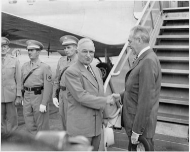 Photograph of President Truman shaking hands with Secretary of State Dean Acheson at the airport in Washington, prior... - NARA - 200118
