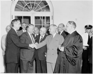 Photograph of President Truman shaking hands with Tom Clark in the White House Rose Garden, on the occasion of... - NARA - 200162