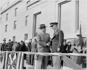Photograph of President Truman shaking hands with General George C. Marshall as he presents him with a medal at a... - NARA - 199262