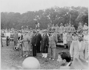 Photograph of President Truman speaking before a microphone during his review of the Nisei 442nd Regimental Combat... - NARA - 199394
