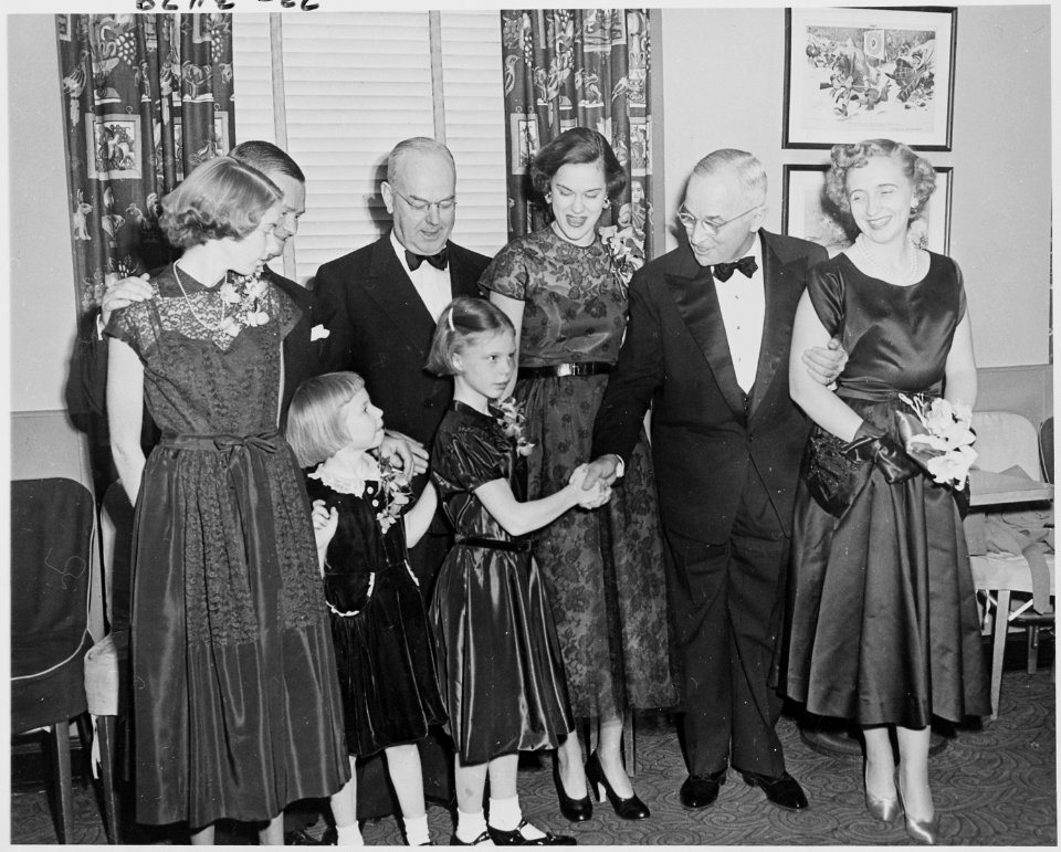 Photograph of President Truman shaking hands with an unidentified young girl at the National Press Club during a... - NARA - 200260