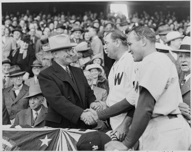 Photograph of President Truman shaking hands with Washington manager Ossie Bluege and New York Yankees manager Bucky... - NARA - 199579