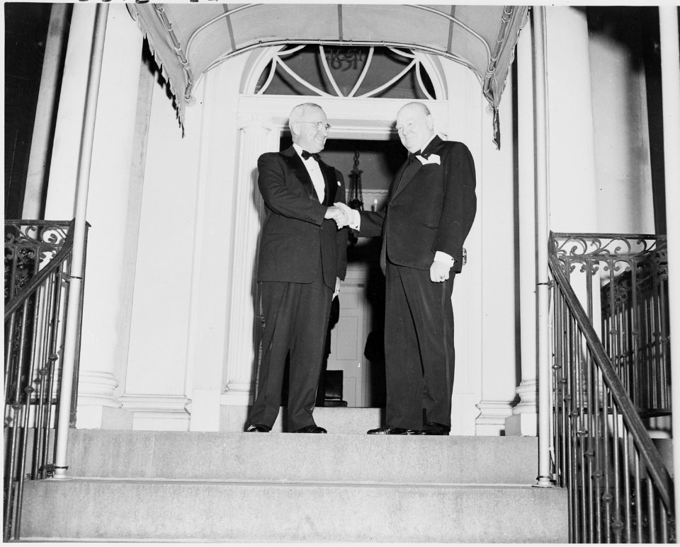 Photograph of President Truman shaking hands with Winston Churchill outside Blair House in Washington, during... - NARA - 200107
