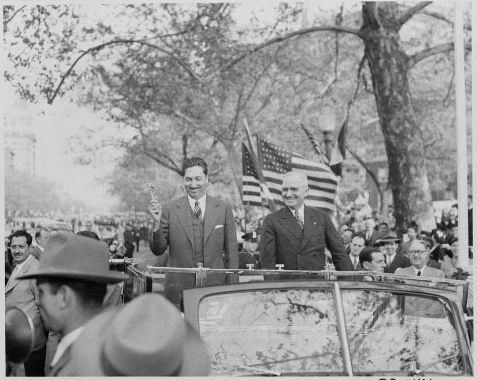 Photograph of President Truman and President Miguel Aleman of Mexico standing in an open limousine during a welcoming... - NARA - 199556