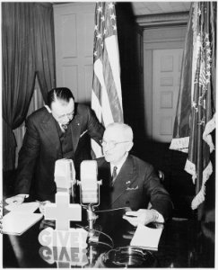 Photograph of President Truman with Basil O'Connor, chairman of the American Red Cross, during a radio broadcast in... - NARA - 200095 photo