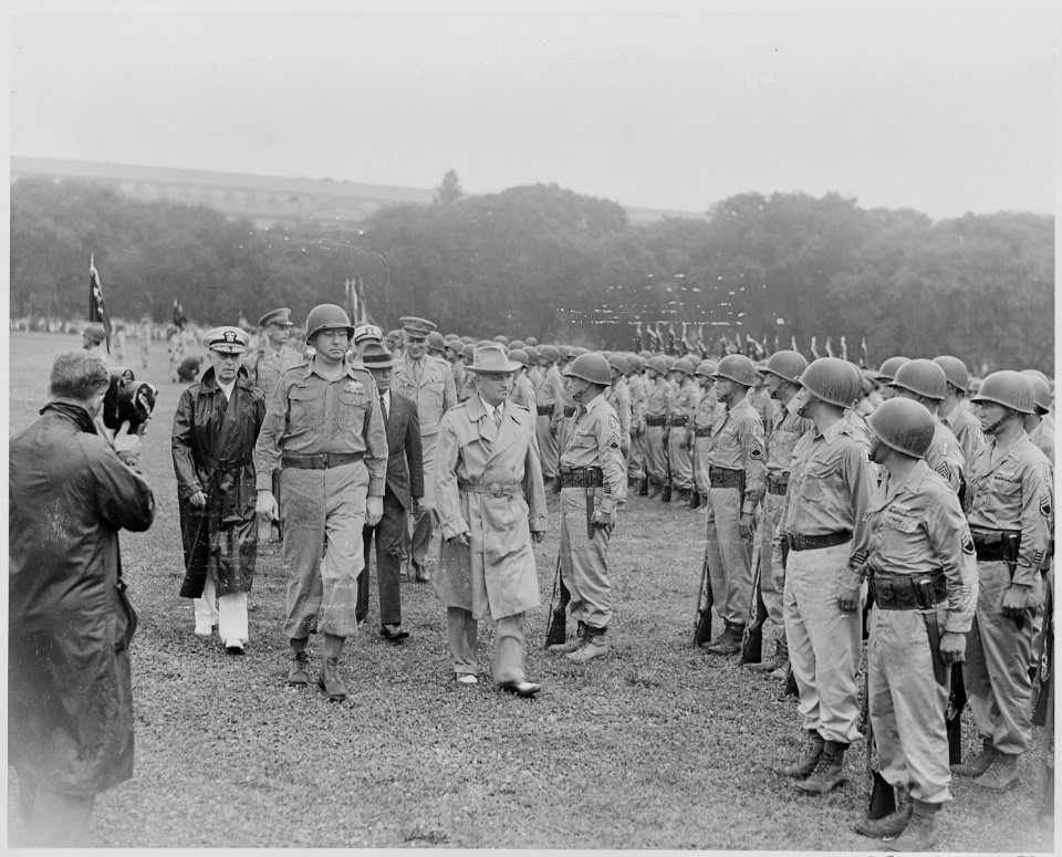 Photograph of President Truman walking past members of the Nisei 442nd Regimental Combat Team as they stand at... - NARA - 199390