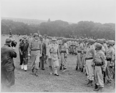 Photograph of President Truman walking past members of the Nisei 442nd Regimental Combat Team as they stand at... - NARA - 199390