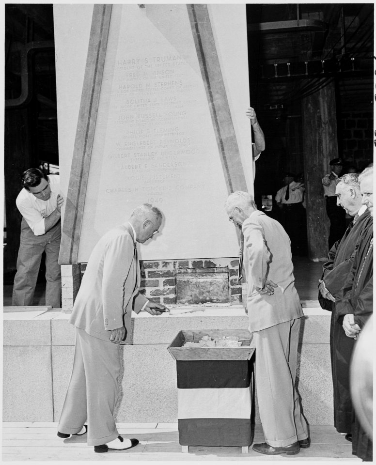 Photograph of President Truman using a trowel to help lay the cornerstone of the new U.S. Courthouse for the District... - NARA - 200213