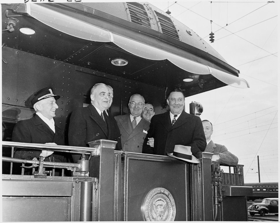 Photograph of President Truman with other dignitaries on the rear platform of his railroad car, the Ferdinand... - NARA - 200248