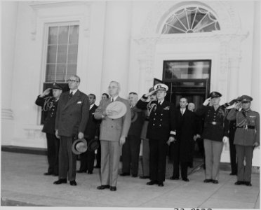 Photograph of President Truman with President Juan Antonio Rios of Chile and others, standing at attention during... - NARA - 199227