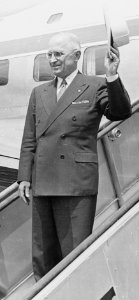 Photograph of President Truman waving from the steps of his airplane as he prepares to leave Washington to attend the... - NARA - 200390 (cropped)