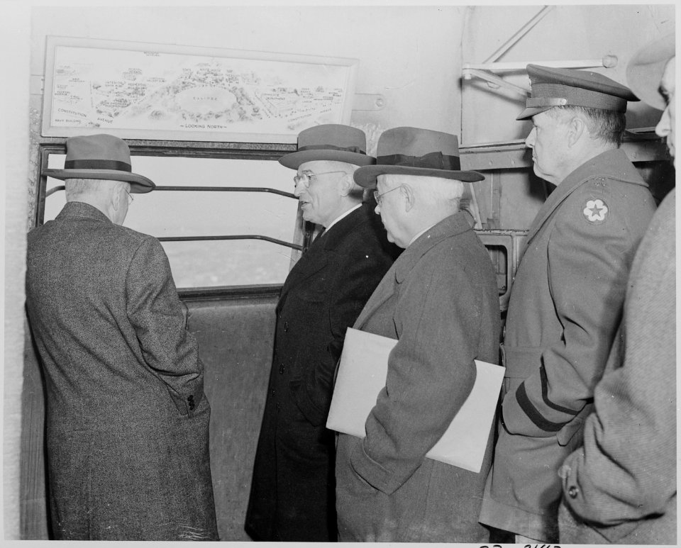 Photograph of President Truman, Secretary of the Interior Harold Ickes, and others looking out an observation window... - NARA - 199298