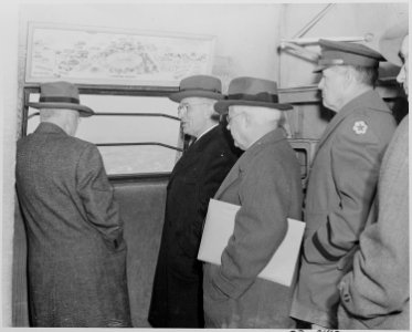 Photograph of President Truman, Secretary of the Interior Harold Ickes, and others looking out an observation window... - NARA - 199298