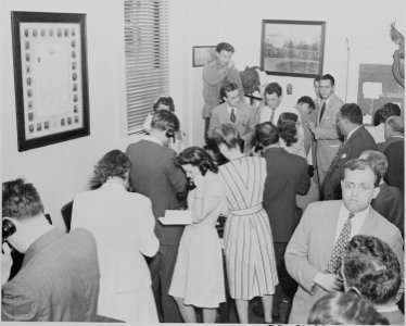 Photograph of reporters on telephones at the White House, transmitting news of the Japanese surrender ending World... - NARA - 199175