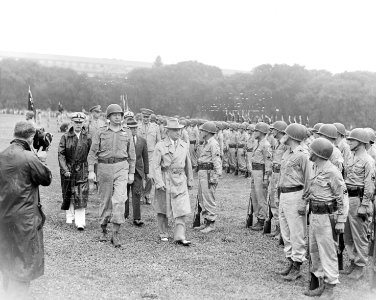 Photograph of President Truman walking past members of the Nisei 442nd Regimental Combat Team as they stand at... - NARA - 199390 photo
