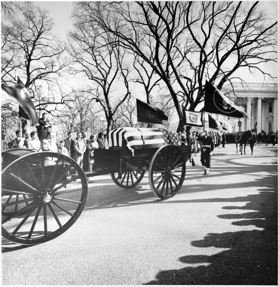 Photograph of the caisson bearing the flag-draped casket of President John F. Kennedy leaving the White House... - NARA - 200455