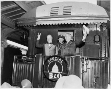Photograph of President Truman waving his hat and Winston Churchill flashing his famous V for Victory sign from the... - NARA - 199350 photo