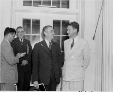 Photograph of several unidentified persons outside the White House on the occasion of the announcement of the... - NARA - 199155