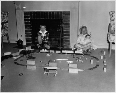Photograph of Steve and Susan Ford (children of Gerald and Betty Ford) Playing with an Electric Train at the Ford... - NARA - 187047 photo