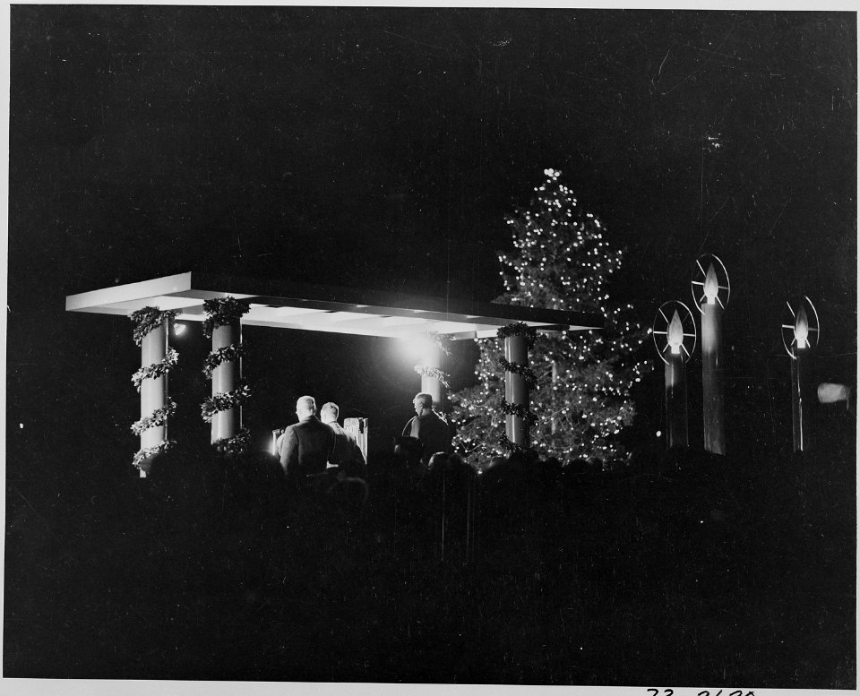 Photograph of the ceremonial lighting of the National Community Christmas Tree on the White House Grounds, with the... - NARA - 199275
