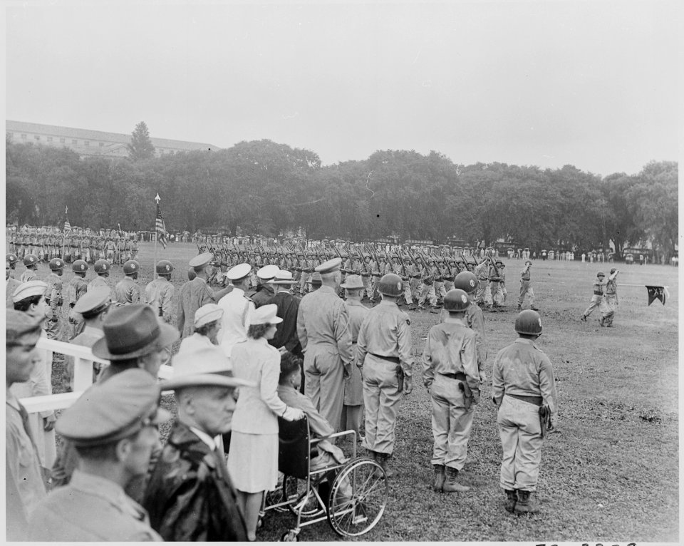 Photograph of the Japanese-American 442nd Regimental Combat Team marching in review past President Truman and other... - NARA - 199393