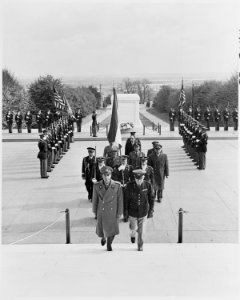 Photograph of the Shah of Iran, followed by a military procession, after laying a wreath at the Tomb of the Unknown... - NARA - 200148