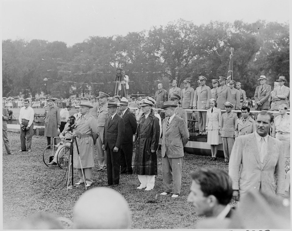 Photograph of President Truman speaking before a microphone during his review of the Nisei 442nd Regimental Combat... - NARA - 199394
