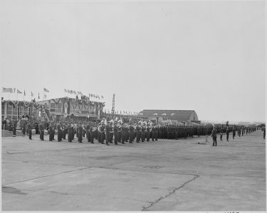 Photograph of troops at attention and military band playing at Washington's National Airport during welcoming... - NARA - 199567