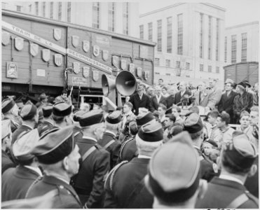 Photograph of Vice President Alben Barkley speaking to a crowd gathered around a boxcar from the French Merci... - NARA - 200079