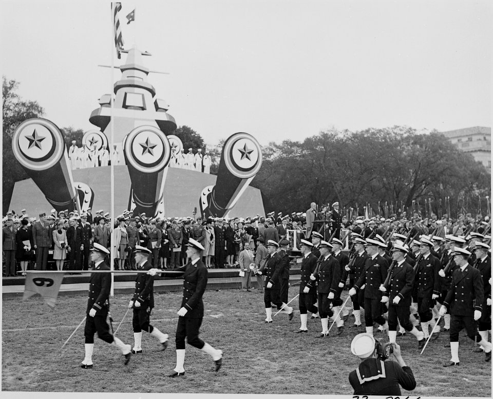 Photograph of troops marching past speaker's platform at ceremonies honoring Admiral Chester Nimitz. - NARA - 199220