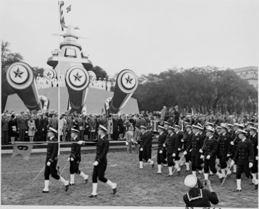 Photograph of troops marching past speaker's platform at ceremonies honoring Admiral Chester Nimitz. - NARA - 199220