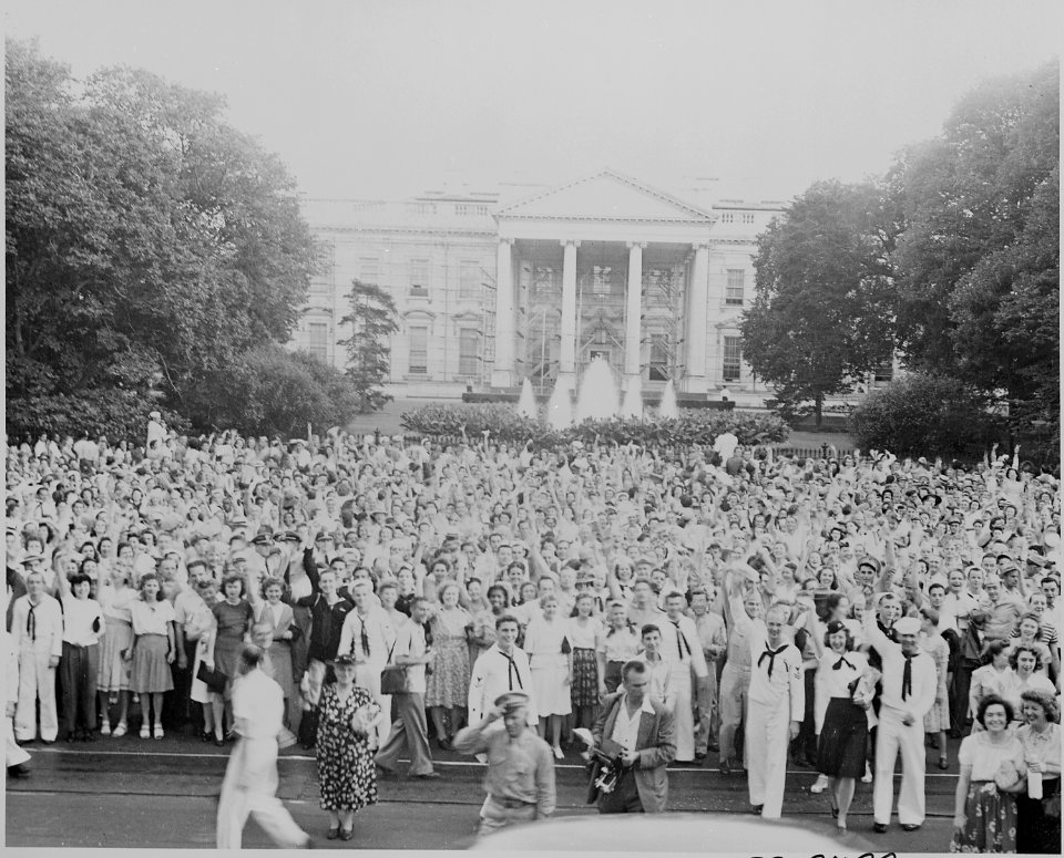 Photograph of throng of people on Pennsylvania Avenue facing the north entrance of the White House, many in uniform... - NARA - 199176