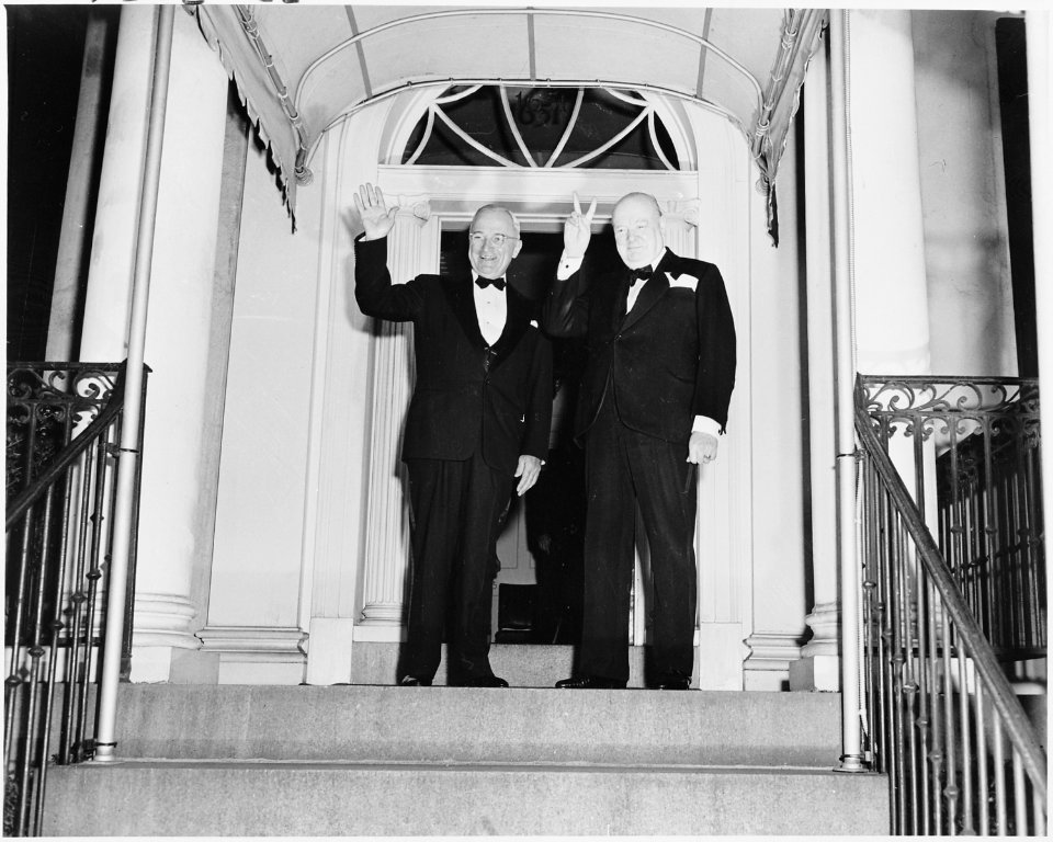 Photograph of Winston Churchill flashing his V for Victory sign and President Truman waving outside Blair House in... - NARA - 200108